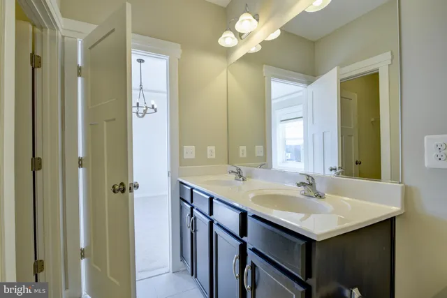 a bathroom with a sink double vanity and a mirror