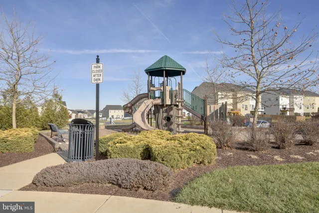a front view of a house with a garden and outdoor seating