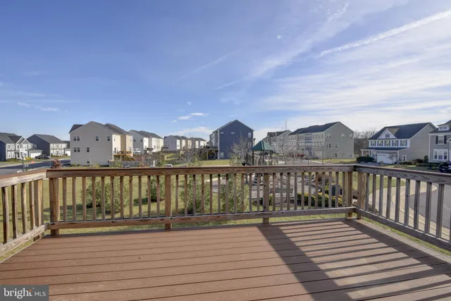 a view of balcony with wooden floor and fence