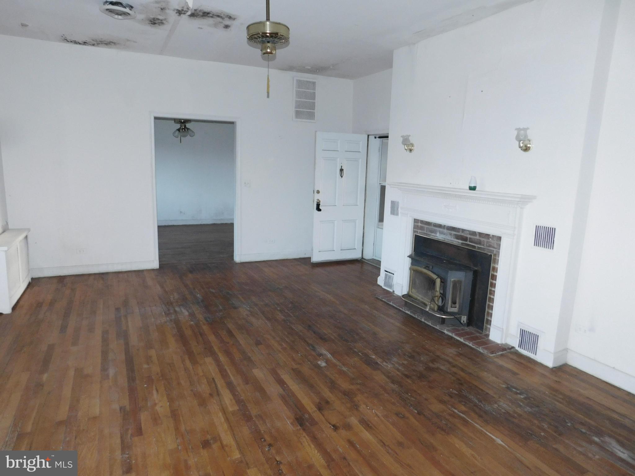 8401 Liberty Road Baltimore, MD 21244 - Photo 13 of 28 a view of empty room with wooden floor and fireplace