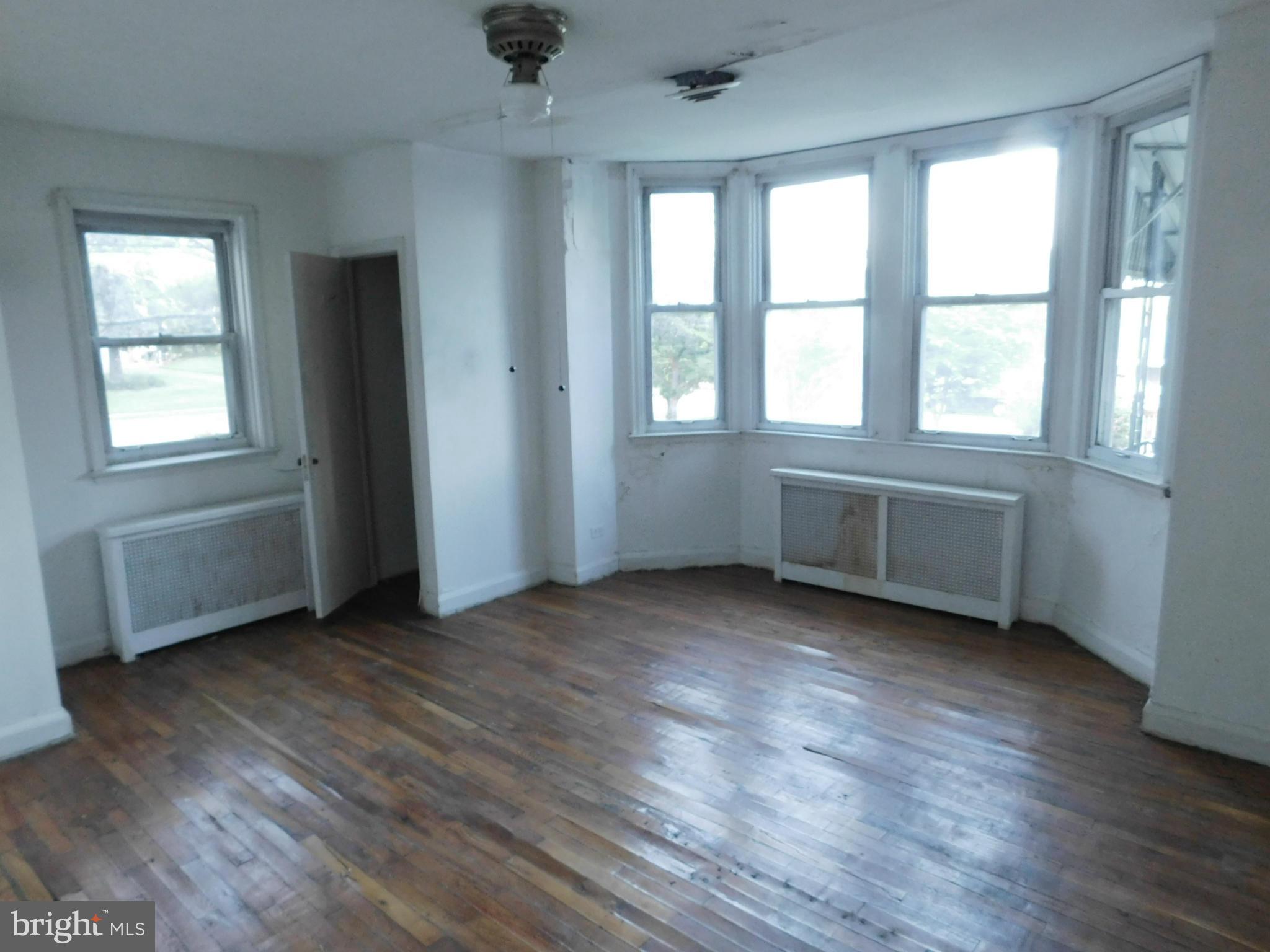 8401 Liberty Road Baltimore, MD 21244 - Photo 20 of 28 an empty room with wooden floor and windows