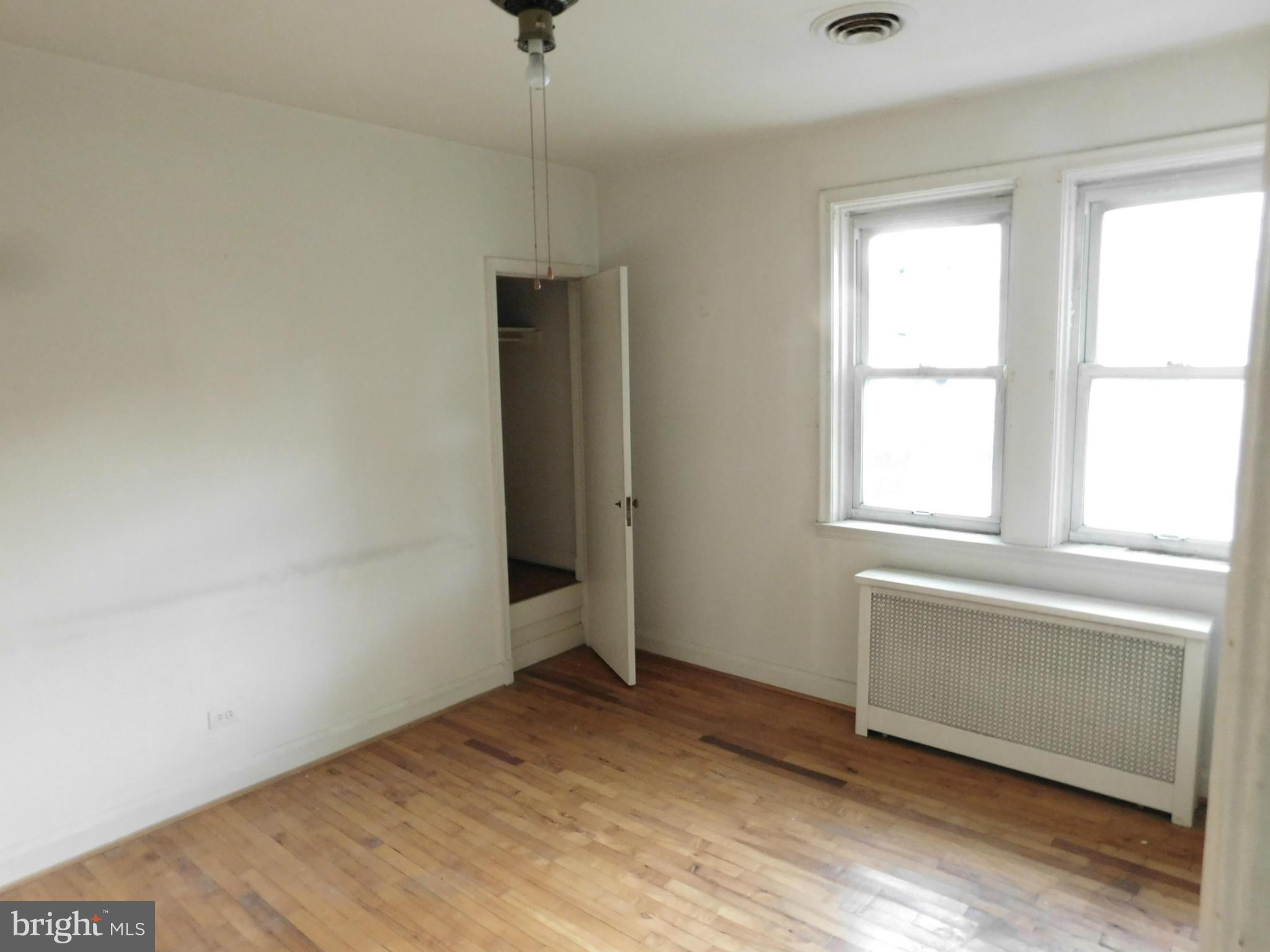 8401 Liberty Road Baltimore, MD 21244 - Photo 25 of 28 an empty room with wooden floor cabinet and windows