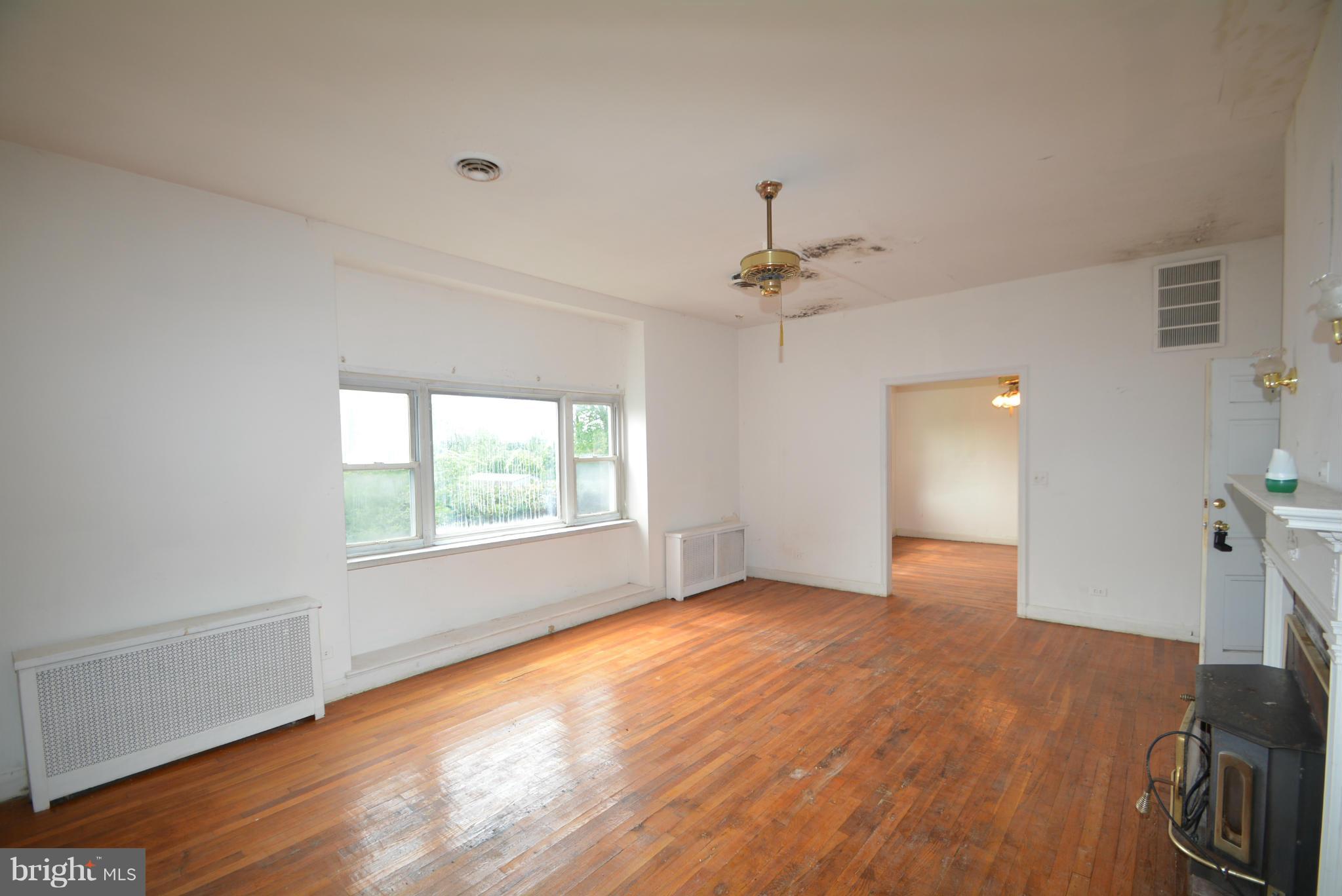 8401 Liberty Road Baltimore, MD 21244 - Photo 5 of 28 a view of an empty room with a window and wooden floor