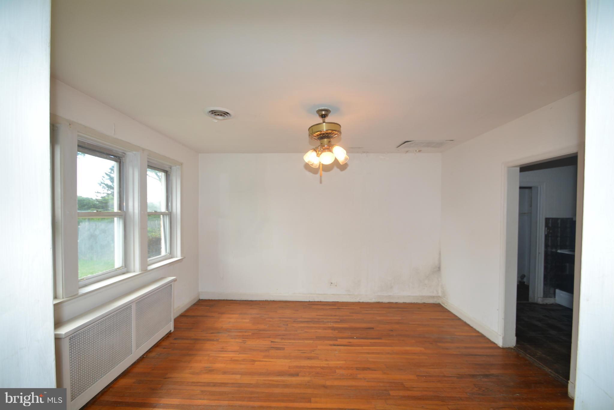 8401 Liberty Road Baltimore, MD 21244 - Photo 6 of 28 a view of an empty room with wooden floor and a window