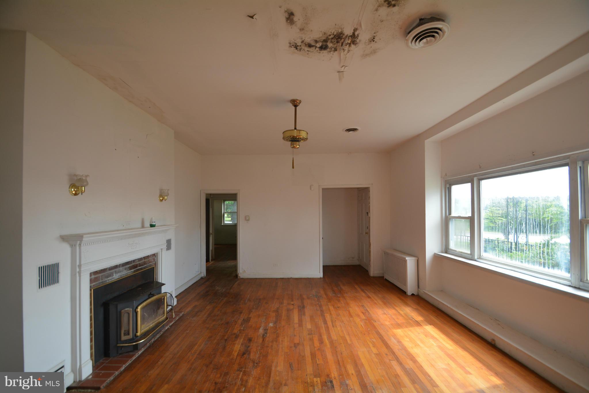 8401 Liberty Road Baltimore, MD 21244 - Photo 7 of 28 a view of empty room with wooden floor and fireplace