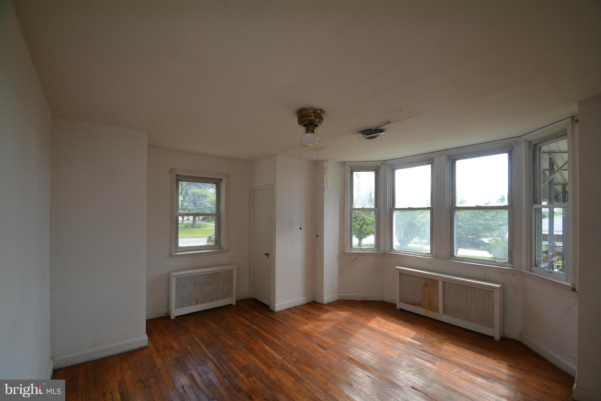 8401 Liberty Road Baltimore, MD 21244 - Photo 8 of 28 a view of an empty room with a window and wooden floor