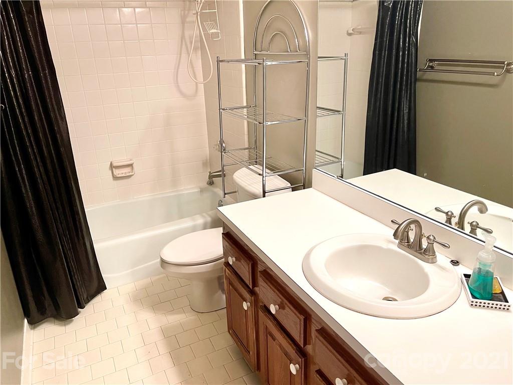 308 Queens Road, Unit 23 Charlotte, NC 28204 - Photo 12 of 22 a bathroom with a sink a toilet and shower