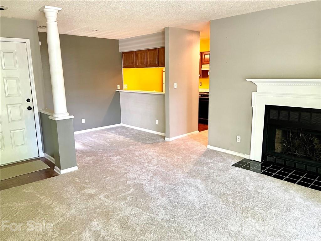 308 Queens Road, Unit 23 Charlotte, NC 28204 - Photo 3 of 22 a view of a livingroom with a fireplace and a window