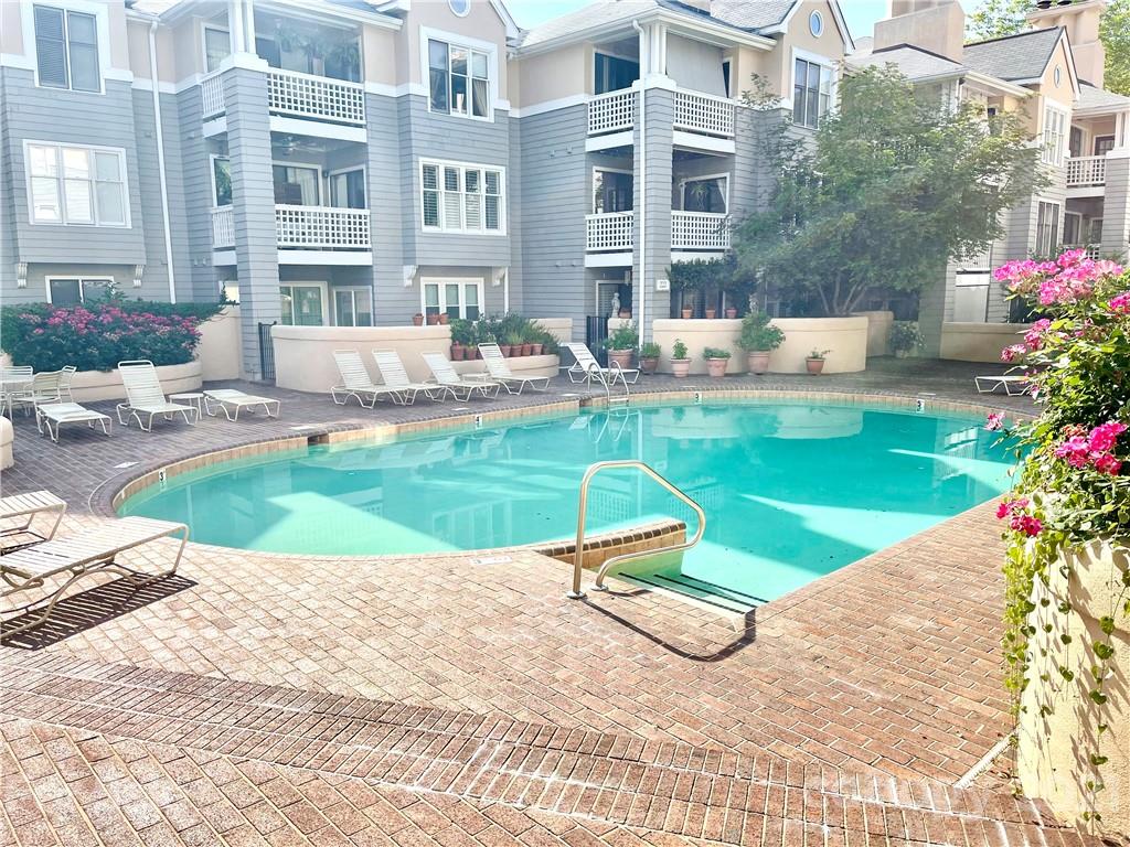 308 Queens Road, Unit 23 Charlotte, NC 28204 - Photo 21 of 22 a view of a swimming pool with back yard and flower garden