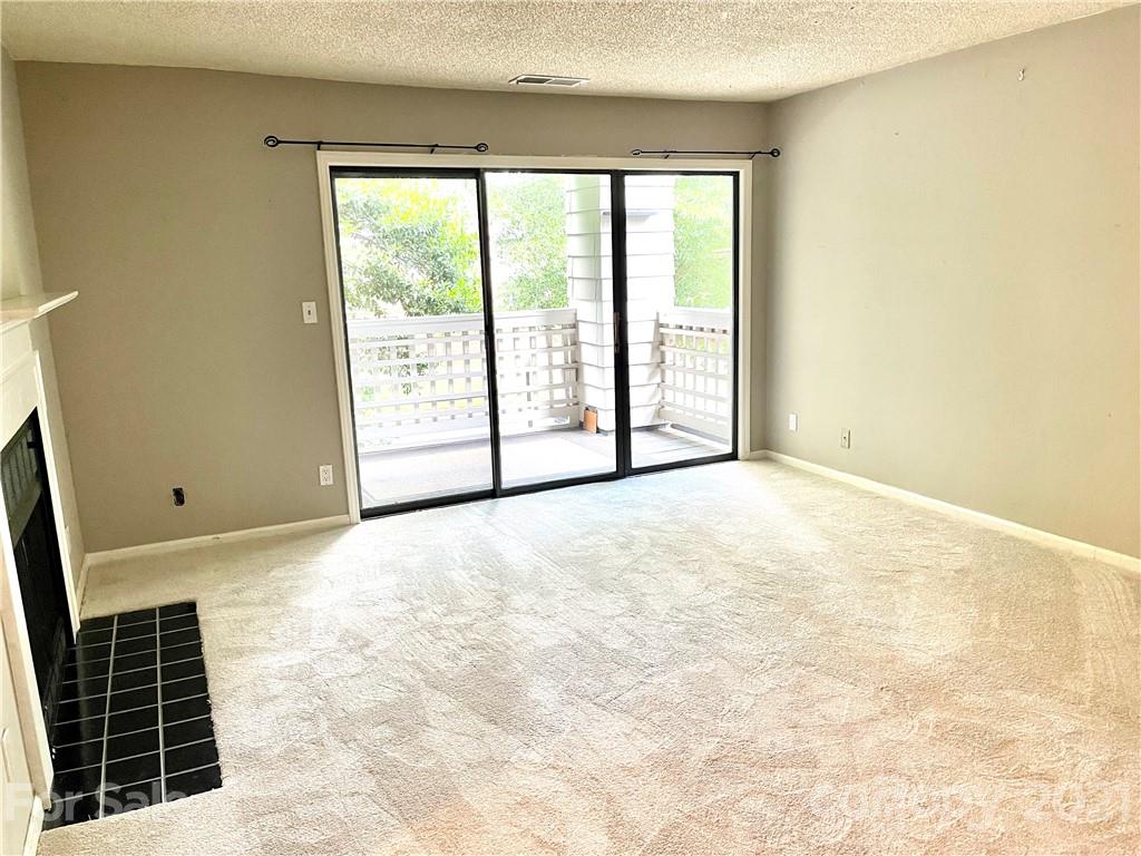 308 Queens Road, Unit 23 Charlotte, NC 28204 - Photo 4 of 22 a view of an empty room with a window