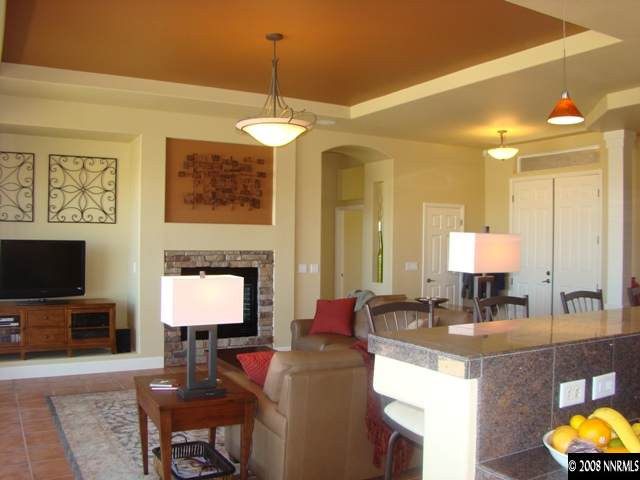 523 Echo Ridge Court Reno, NV 89511 - Photo 4 of 9 a view of living room kitchen with stainless steel appliances granite countertop couches a fireplace with wooden floor