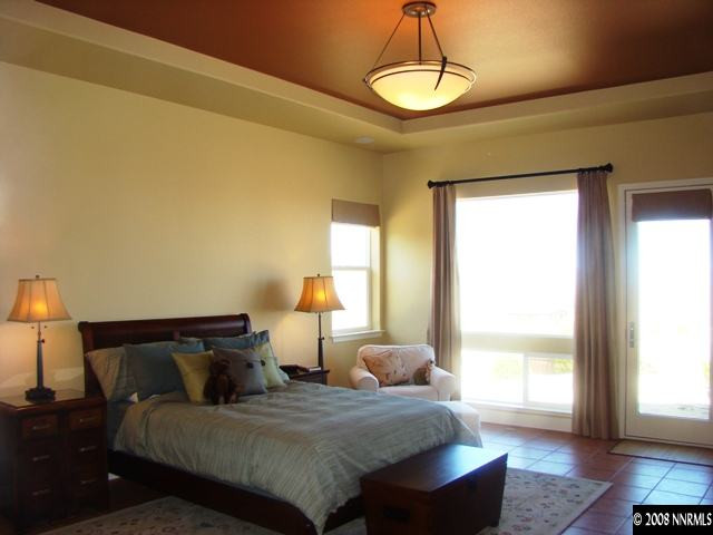 523 Echo Ridge Court Reno, NV 89511 - Photo 6 of 9 a bedroom with a bed and a lamp
