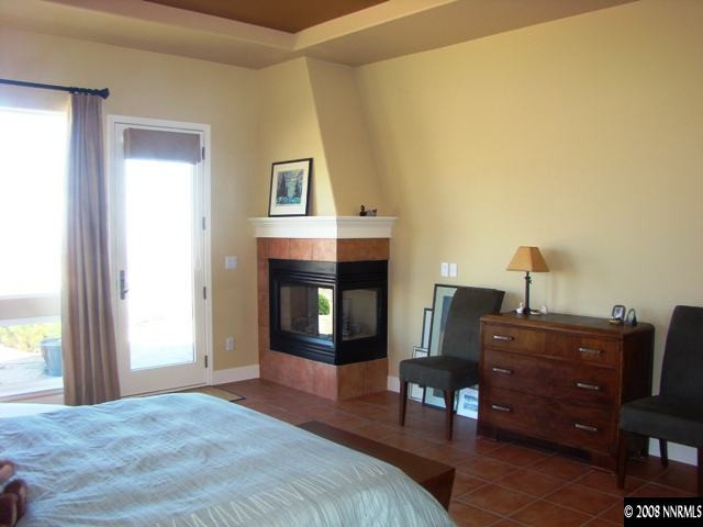 523 Echo Ridge Court Reno, NV 89511 - Photo 7 of 9 a bedroom with a bed and a fireplace