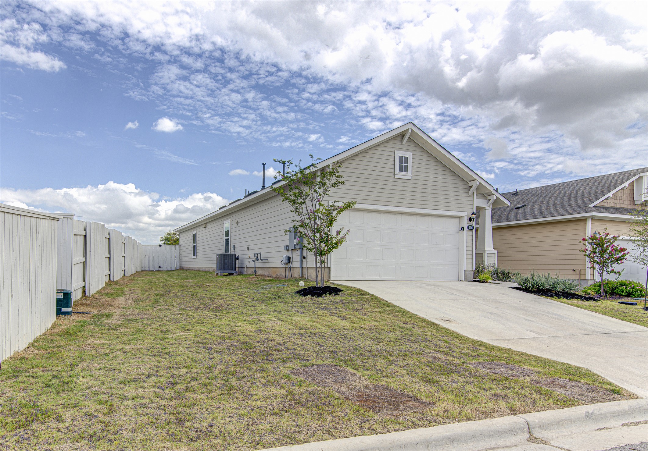 156 Tillage Road Elgin, TX 78621 - Photo 2 of 25 A charming residence with a spacious garage and verdant yard, offering peaceful suburban living.