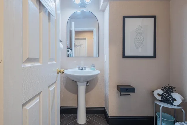 a bathroom with a sink toilet and mirror