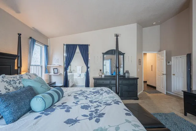 a bedroom with a large bed and a dresser