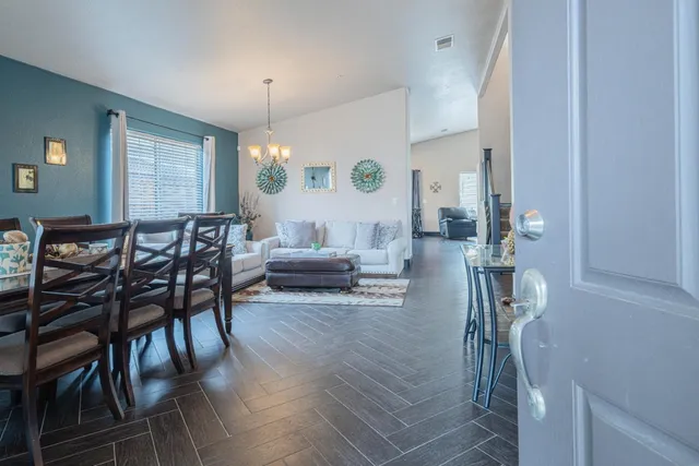 a living room with furniture a table and chairs