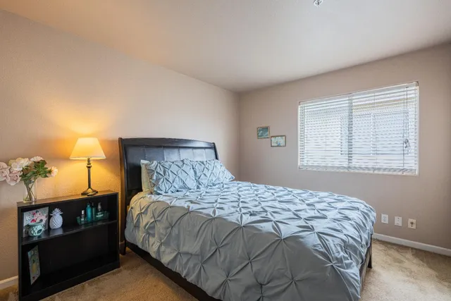 a bedroom with a bed and window