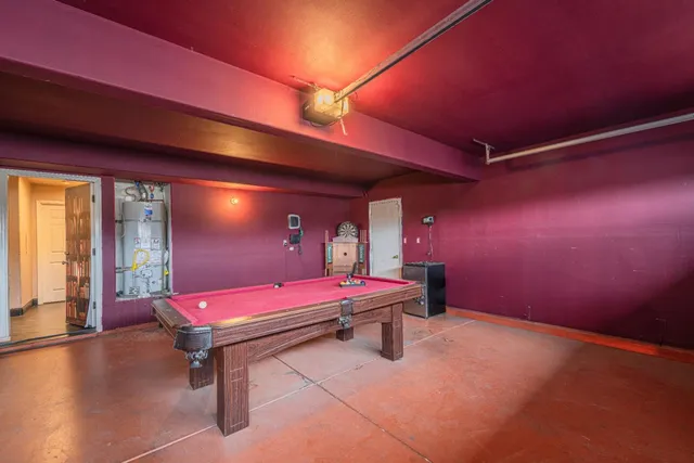 a room with table tennis pool table and a rug
