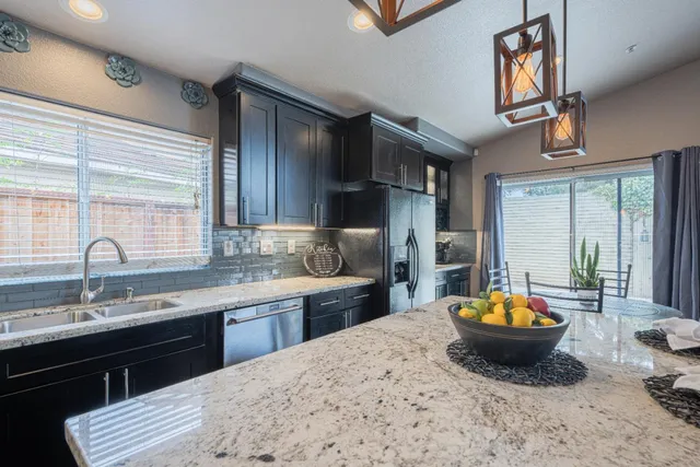 a kitchen with a sink a stove and a wooden cabinets