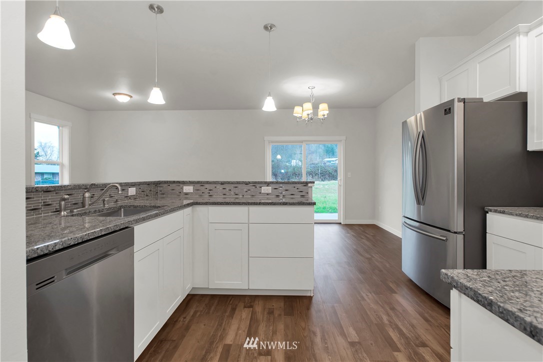 674 Southwest 20th Street Chehalis, WA 98532 - Photo 13 of 29 a kitchen with granite countertop a refrigerator and a sink