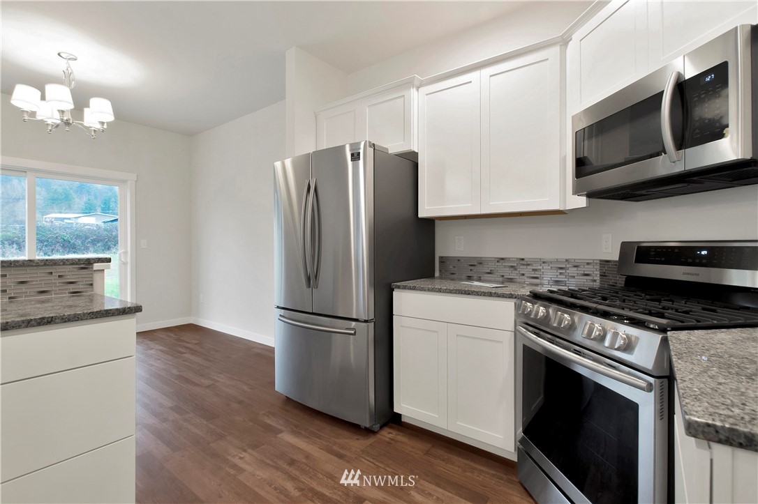 674 Southwest 20th Street Chehalis, WA 98532 - Photo 14 of 29 a kitchen with stainless steel appliances granite countertop a refrigerator stove and microwave