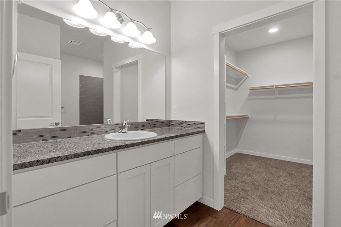 674 Southwest 20th Street Chehalis, WA 98532 - Photo 18 of 29 a bathroom with a granite countertop sink and a mirror