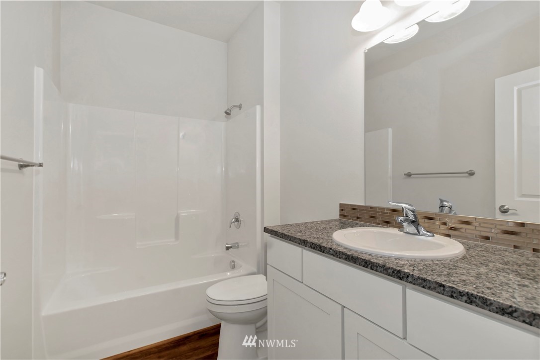 674 Southwest 20th Street Chehalis, WA 98532 - Photo 26 of 29 a bathroom with a granite countertop sink toilet and shower