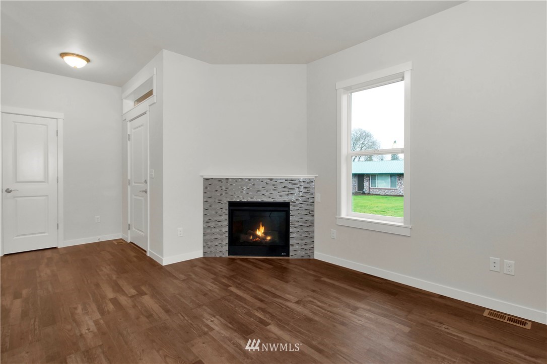674 Southwest 20th Street Chehalis, WA 98532 - Photo 4 of 29 a view of an empty room with a window and fireplace