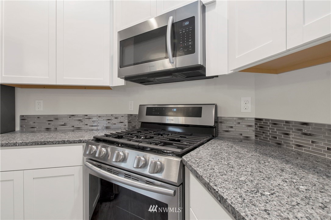 674 Southwest 20th Street Chehalis, WA 98532 - Photo 10 of 29 a kitchen with stainless steel appliances granite countertop white cabinets and a stove