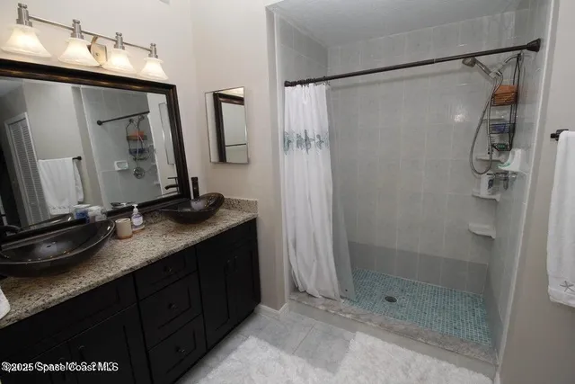 a bathroom with a granite countertop sink mirror and double