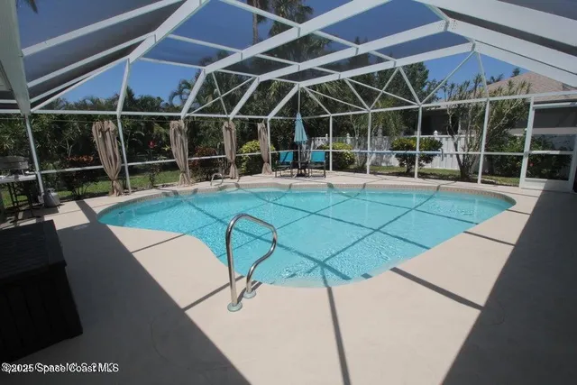 a view of a backyard with table and chairs