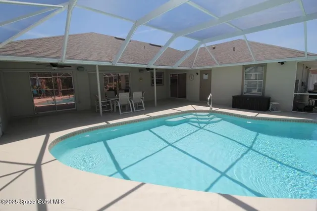 a backyard of a house with yard and outdoor seating