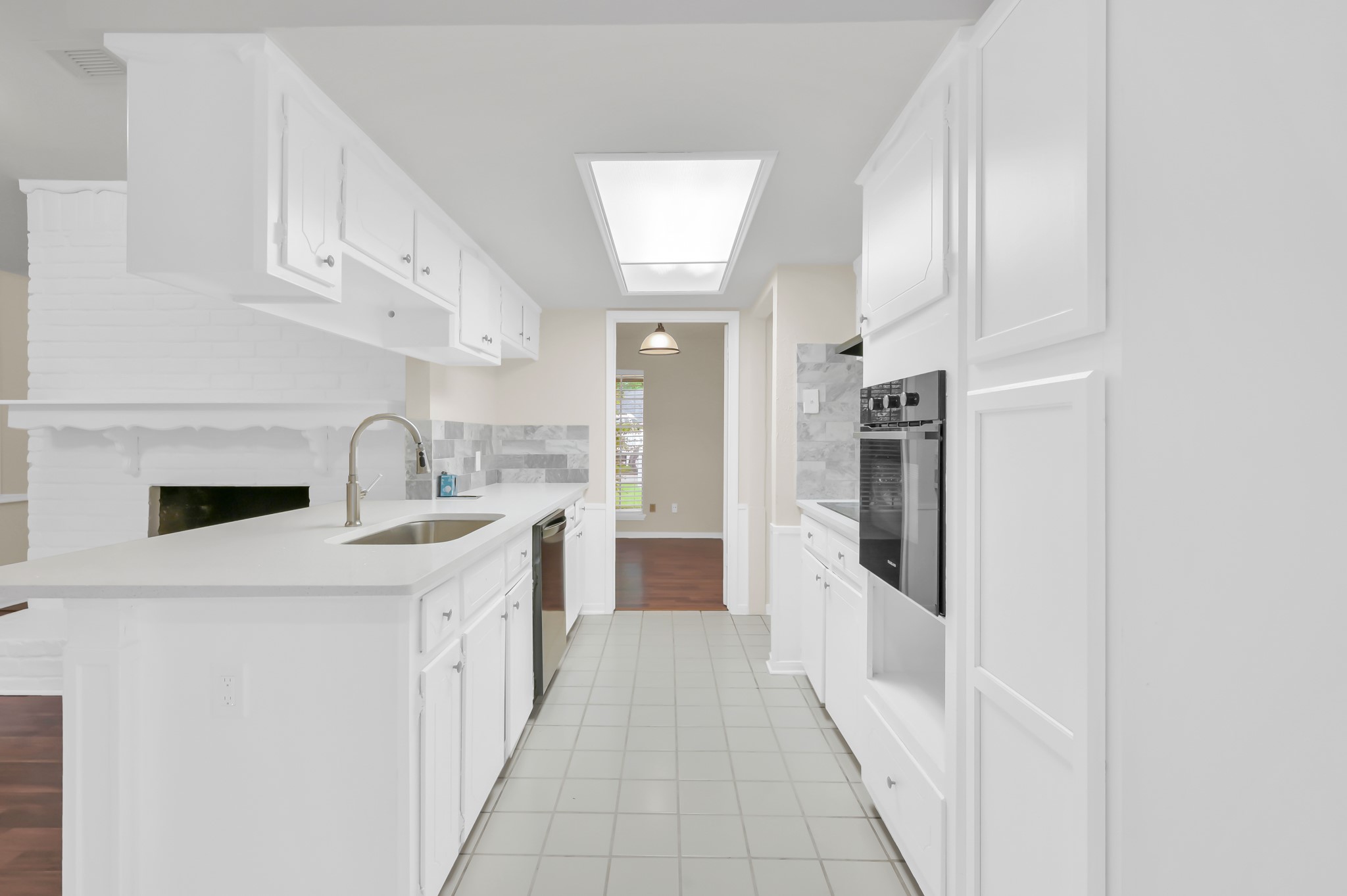 29610 Loddington Street Spring, TX 77386 - Photo 16 of 40 a kitchen with white cabinets and white appliances