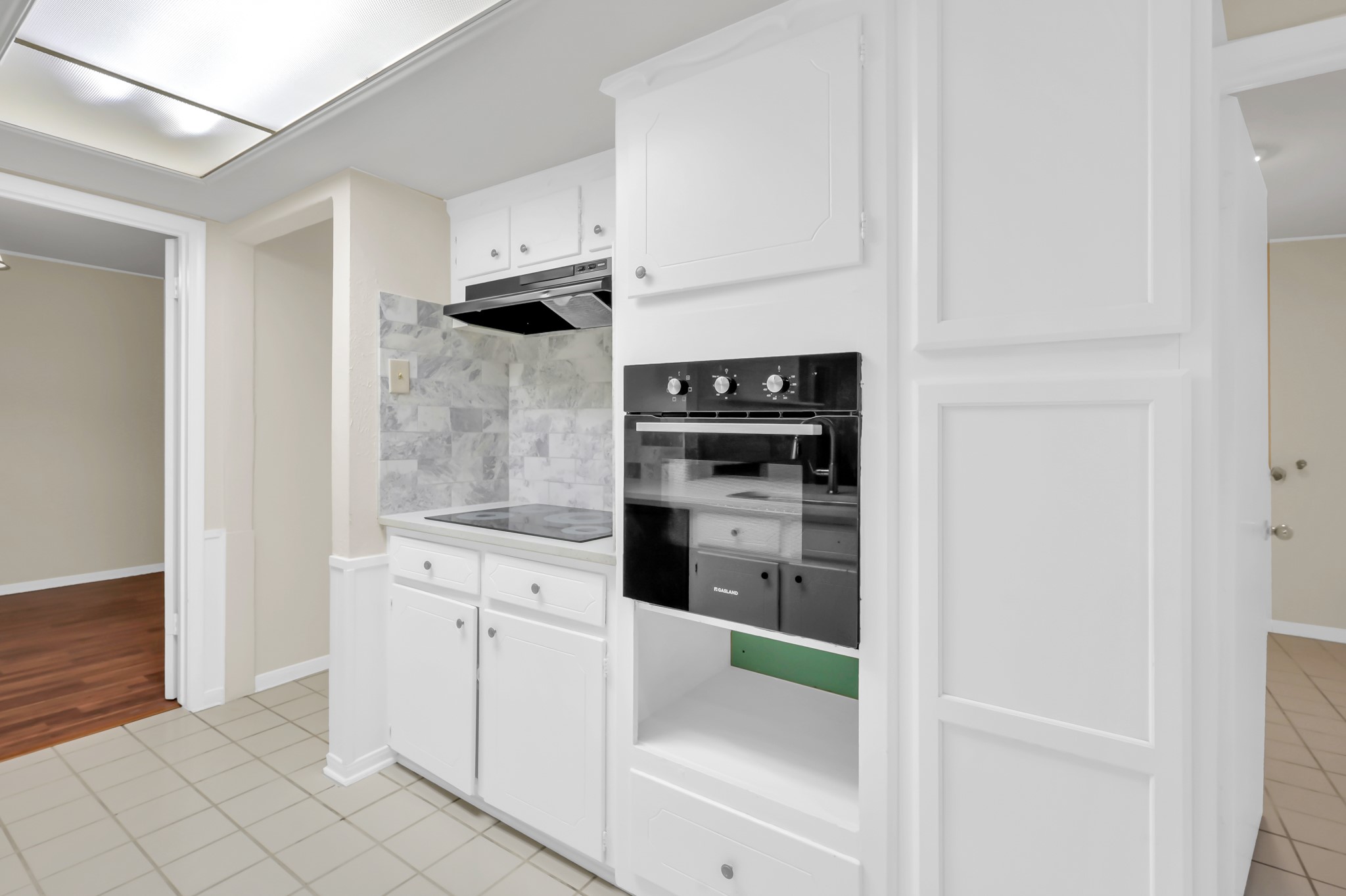 29610 Loddington Street Spring, TX 77386 - Photo 18 of 40 a kitchen with white cabinets and white appliances