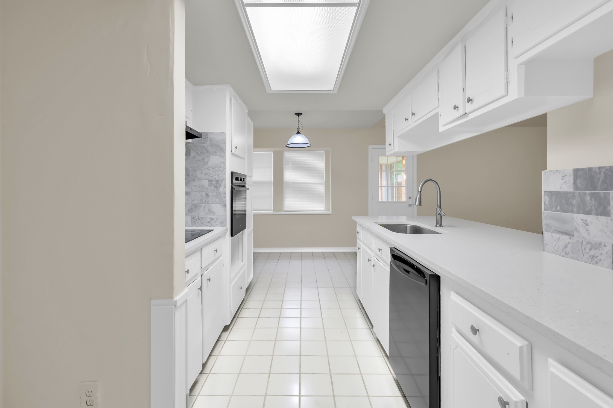 29610 Loddington Street Spring, TX 77386 - Photo 19 of 40 a large white kitchen with a sink and dishwasher a refrigerator with white cabinets