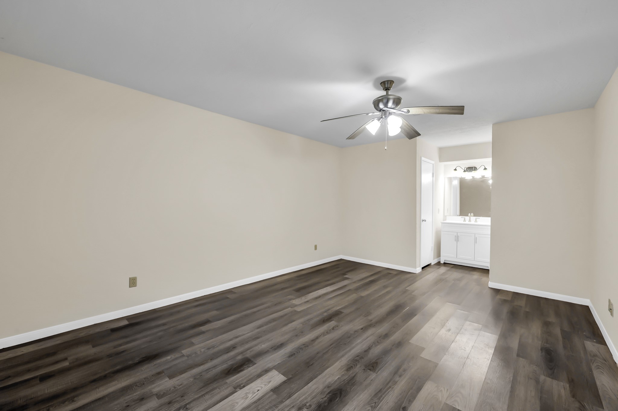 29610 Loddington Street Spring, TX 77386 - Photo 22 of 40 a view of an empty room with chandelier fan and wooden floor