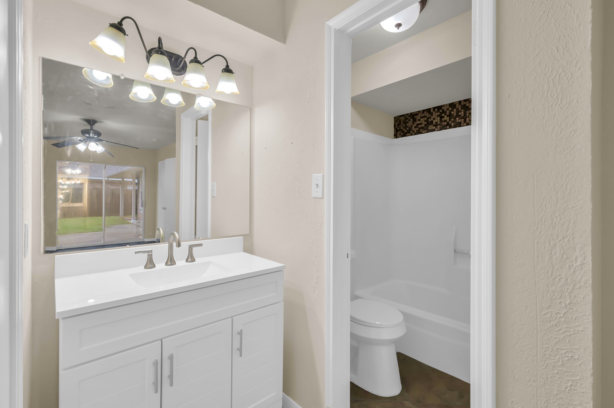 29610 Loddington Street Spring, TX 77386 - Photo 25 of 40 a bathroom with a toilet sink and mirror