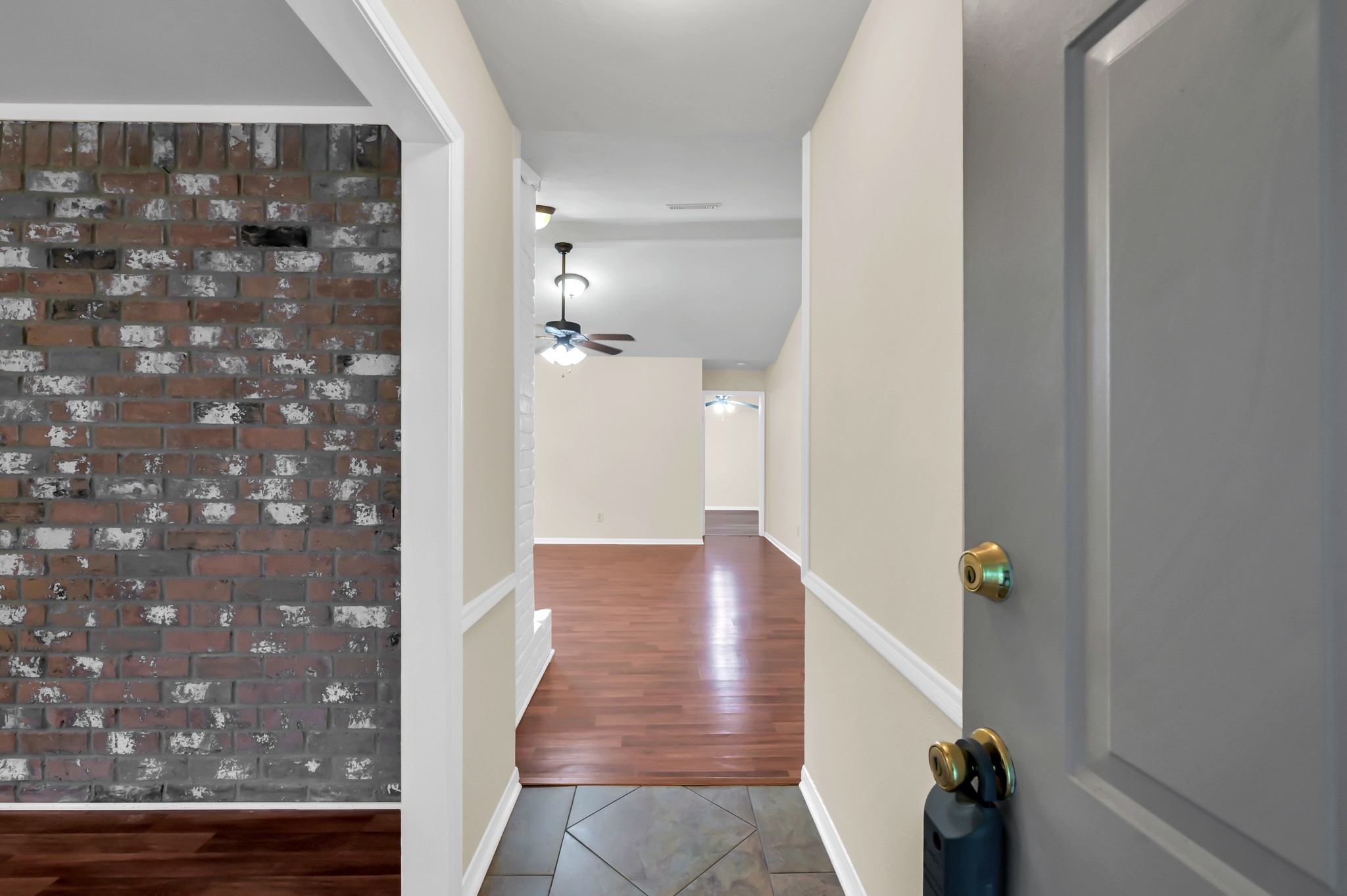 29610 Loddington Street Spring, TX 77386 - Photo 4 of 40 a view of a hallway with wooden floor and a bathroom