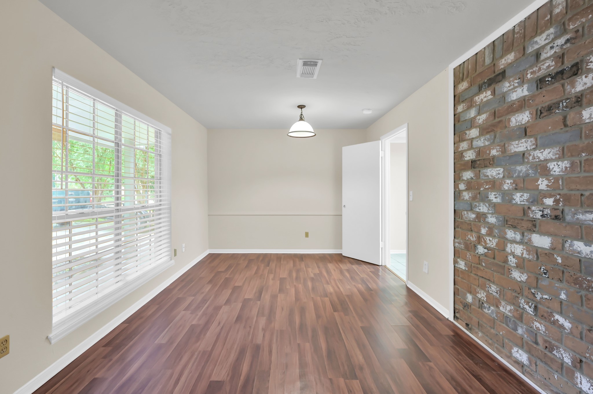 29610 Loddington Street Spring, TX 77386 - Photo 5 of 40 a view of an empty room with wooden floor and a window