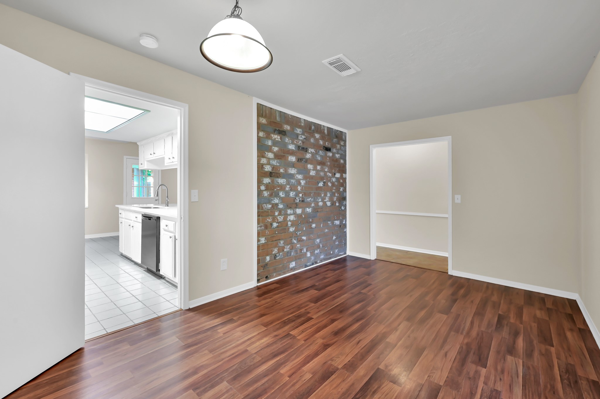 29610 Loddington Street Spring, TX 77386 - Photo 6 of 40 an empty room with wooden floor and way to kitchen