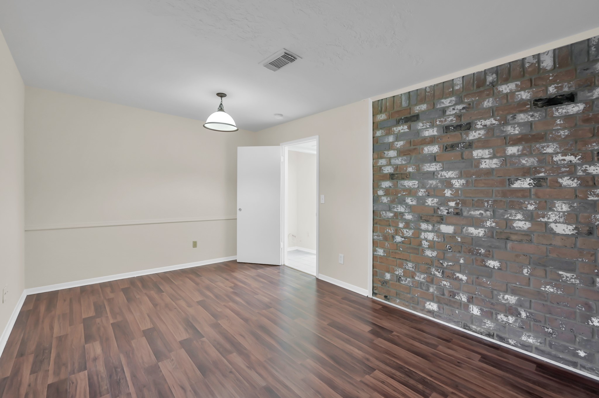 29610 Loddington Street Spring, TX 77386 - Photo 7 of 40 a view of an empty room with wooden floor and a window