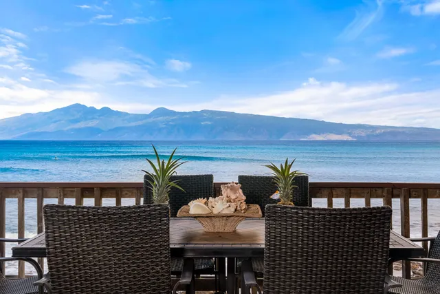 a view of balcony with table and chairs
