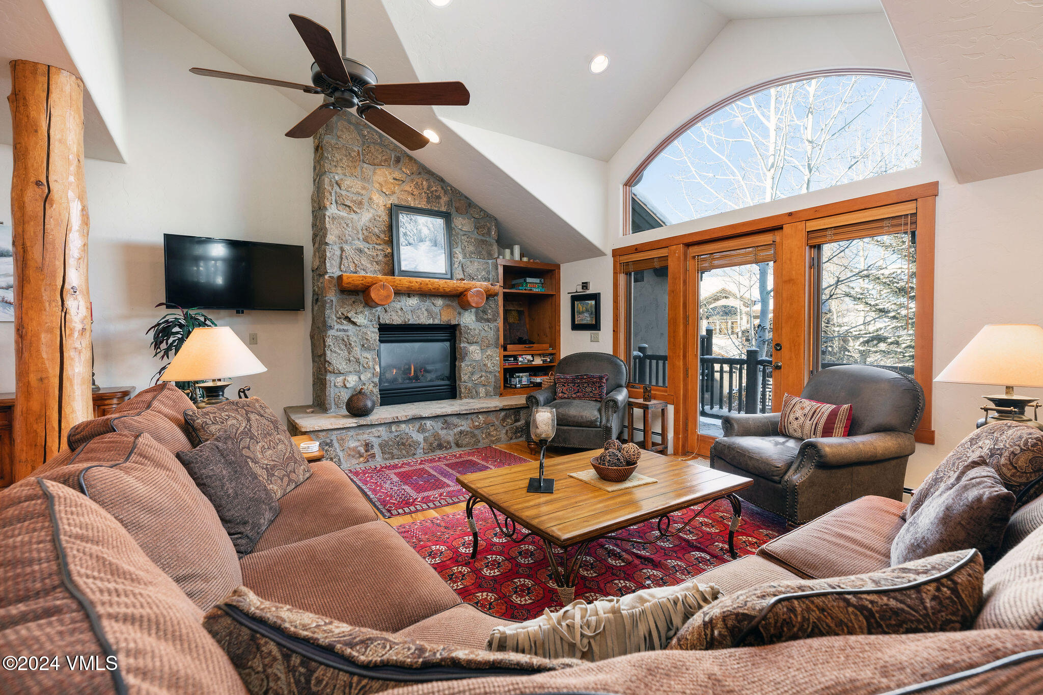 42 Knudson Ranch Road Edwards, CO 81632 - Photo 2 of 22 a living room with furniture a fireplace and a flat screen tv