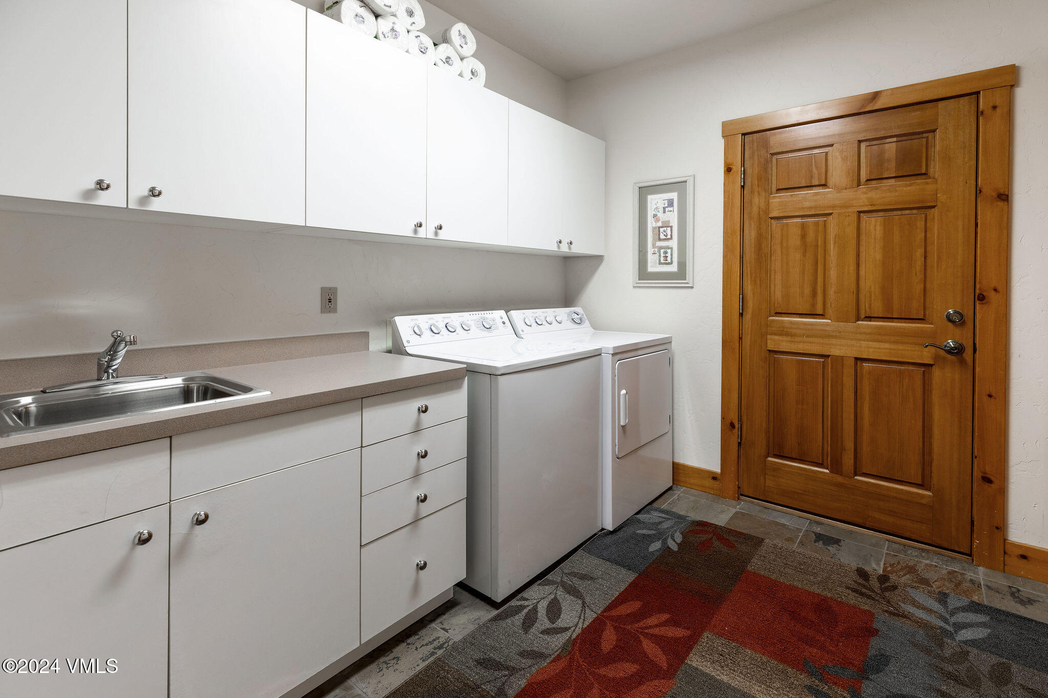 42 Knudson Ranch Road Edwards, CO 81632 - Photo 21 of 22 a utility room with cabinets washer and dryer