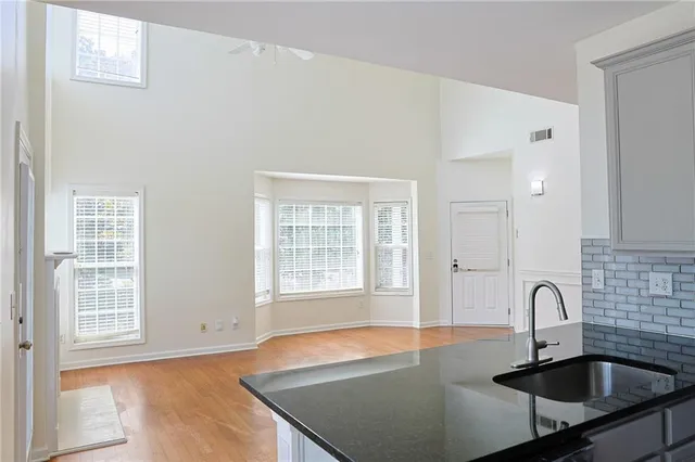 a kitchen with granite countertop a sink and a window