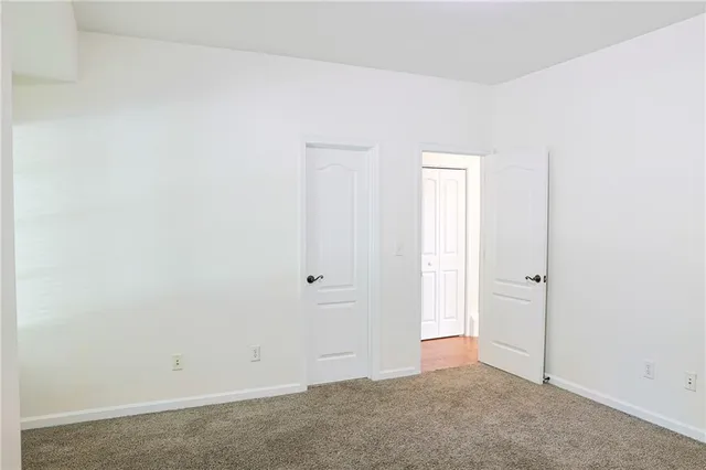 an empty room with closet area