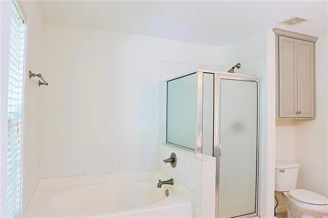 a bathroom with a bathtub and a toilet