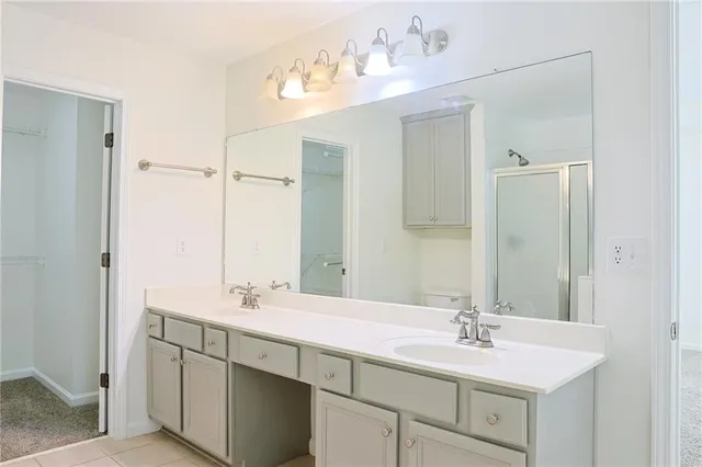 a bathroom with a sink double vanity and mirror