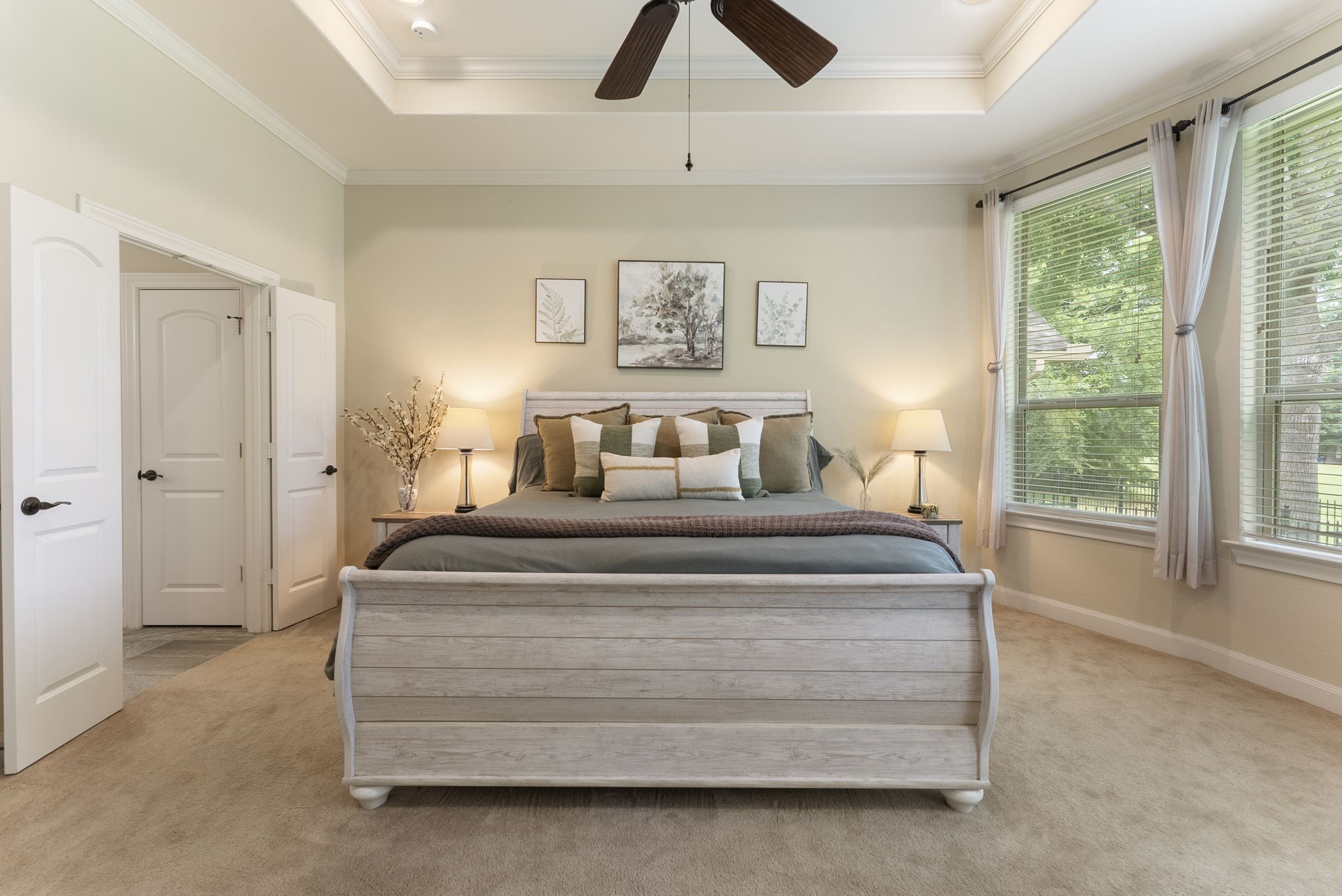 4787 Jackson Square Drive Conroe, TX 77304 - Photo 18 of 35 Tucked away in its own private wing, the primary bedroom offers a serene retreat designed for relaxation and tranquility. Wake up to picturesque views of the lush golf course, where the rolling greens and natural beauty create a sense of calm and connection to the outdoors. This secluded haven ensures peace and quiet, allowing you to unwind in complete comfort while enjoying the luxurious privacy you deserve.